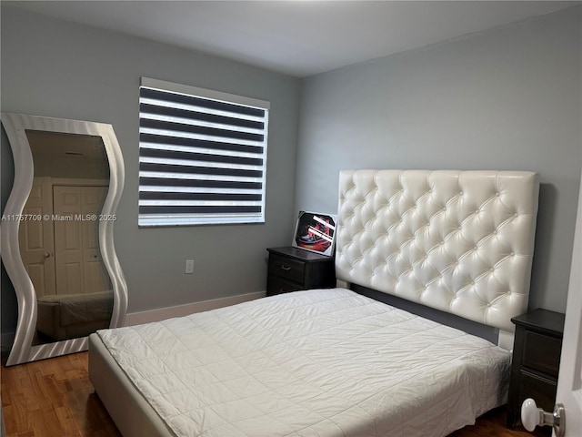 bedroom with dark wood-style floors