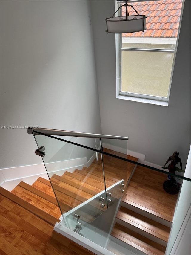 stairs featuring baseboards and wood finished floors