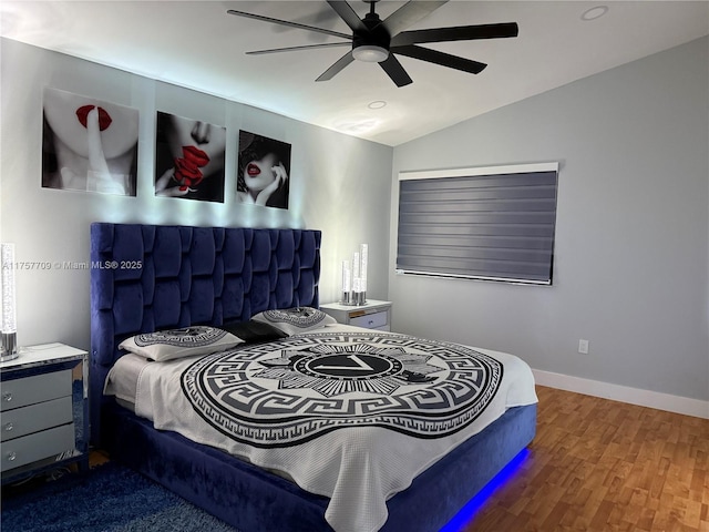 bedroom with lofted ceiling, ceiling fan, baseboards, and wood finished floors