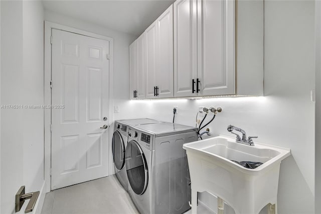laundry area with separate washer and dryer, cabinet space, and a sink