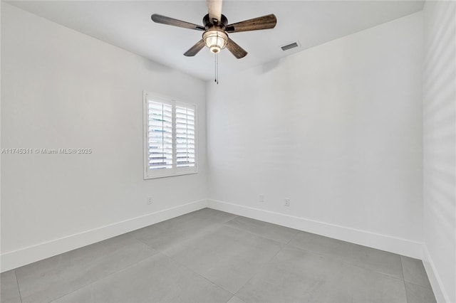 empty room with visible vents, baseboards, and ceiling fan