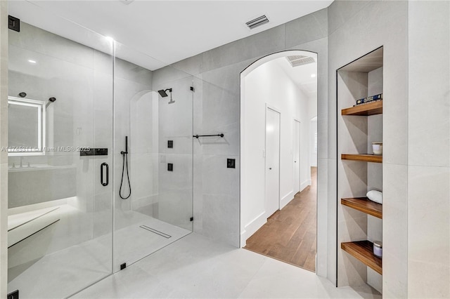 bathroom featuring built in features, visible vents, and a stall shower
