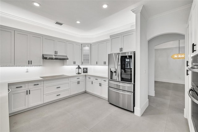 kitchen featuring visible vents, arched walkways, stainless steel refrigerator with ice dispenser, under cabinet range hood, and black electric stovetop