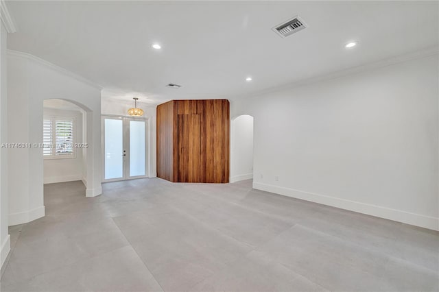 unfurnished room featuring crown molding, recessed lighting, visible vents, and arched walkways
