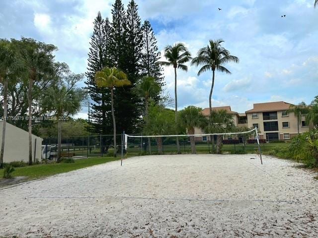 view of property's community with volleyball court and fence