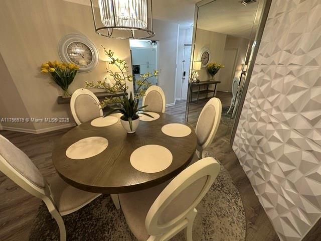 dining area featuring a chandelier and visible vents