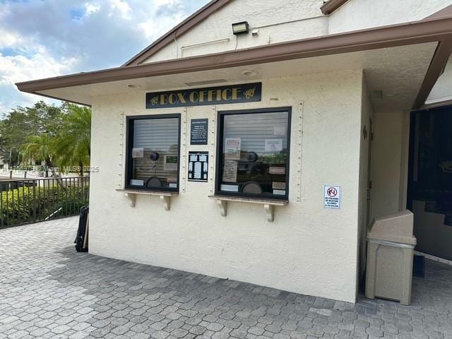 view of home's exterior with fence and stucco siding