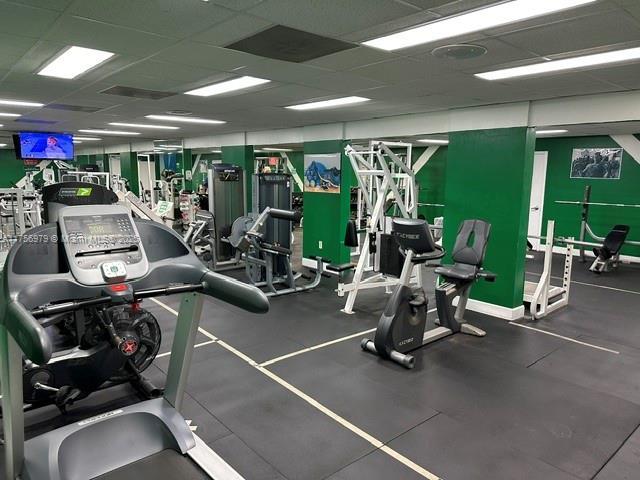 gym with a paneled ceiling