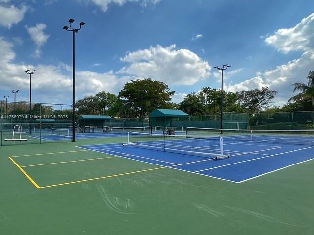 view of tennis court featuring fence