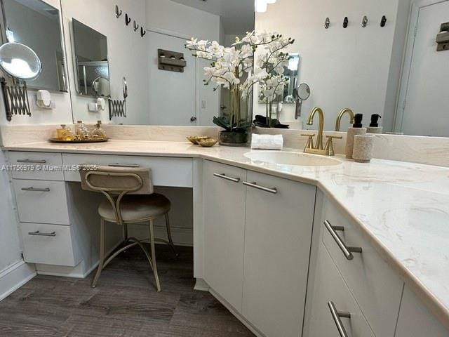 bathroom with wood finished floors and vanity