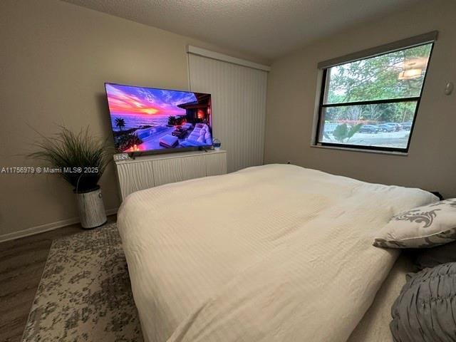 bedroom featuring baseboards and a textured ceiling