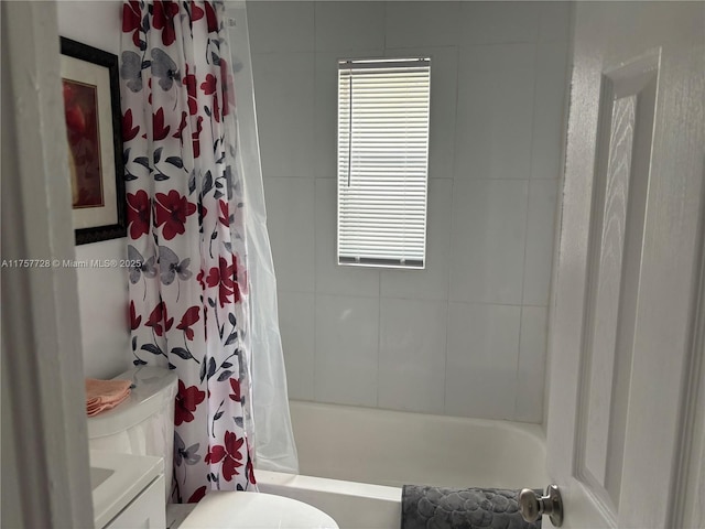 bathroom with vanity, shower / bath combo with shower curtain, and toilet