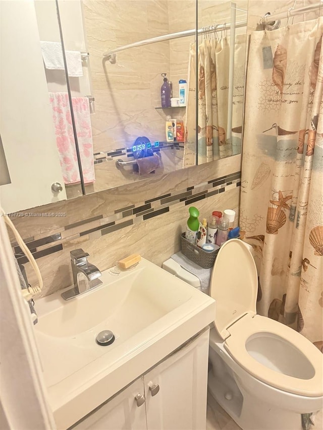 bathroom featuring tile walls, backsplash, toilet, vanity, and a shower with curtain