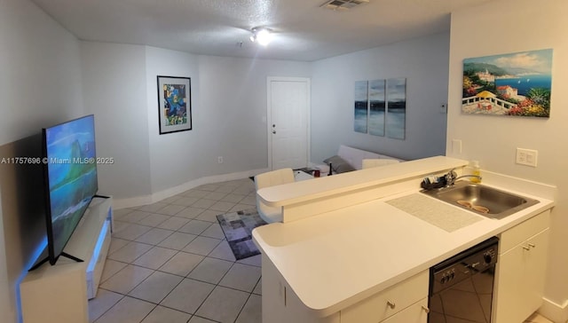 kitchen featuring light countertops, black dishwasher, light tile patterned floors, a peninsula, and a sink