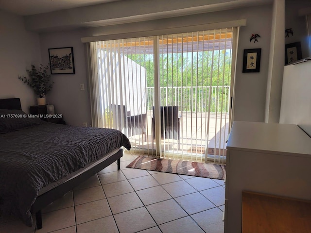 bedroom featuring light tile patterned floors and access to outside