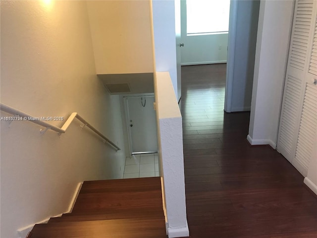 stairway with baseboards and wood finished floors