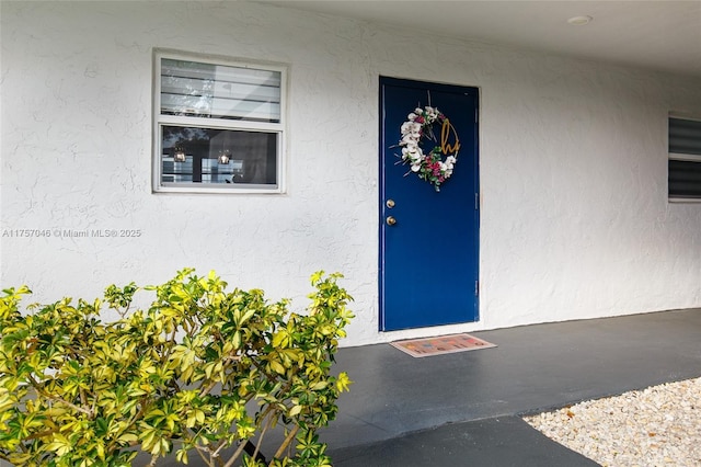 entrance to property with stucco siding