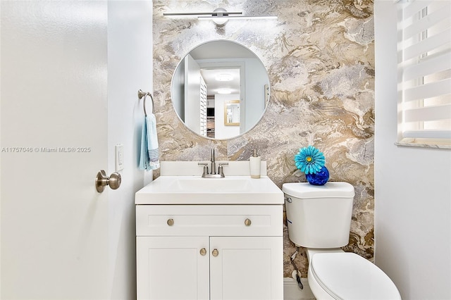 half bath featuring toilet and vanity