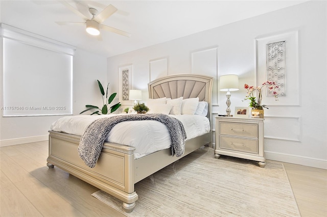 bedroom with light wood finished floors, baseboards, and a ceiling fan