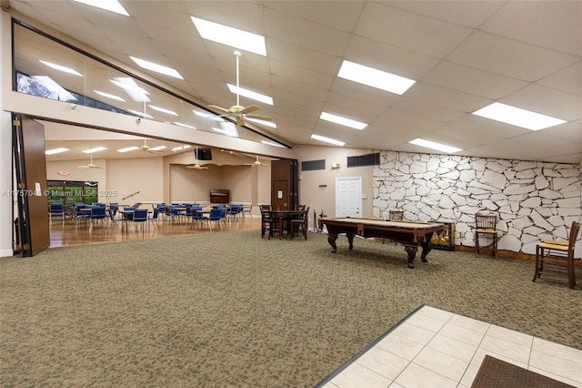 game room featuring carpet floors, a towering ceiling, and a paneled ceiling