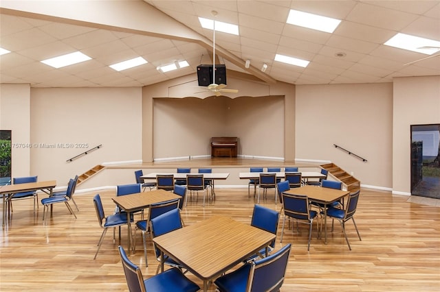 game room featuring ceiling fan, light wood-type flooring, a paneled ceiling, and baseboards