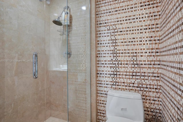 bathroom with toilet and a stall shower