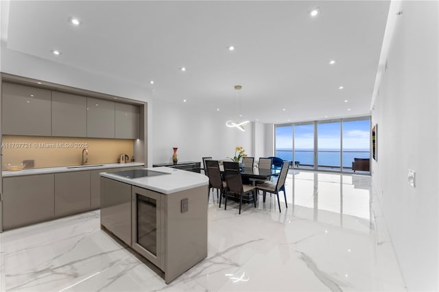 kitchen featuring modern cabinets, a wall of windows, a sink, and gray cabinetry