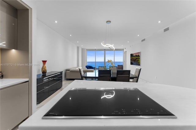 kitchen with expansive windows, visible vents, light countertops, and open floor plan