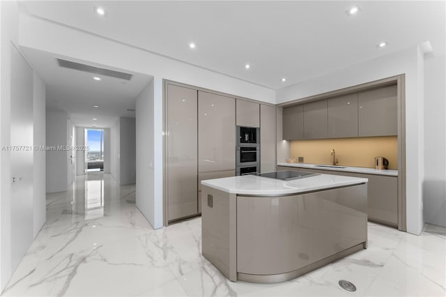 kitchen featuring marble finish floor, stainless steel appliances, gray cabinets, a sink, and modern cabinets