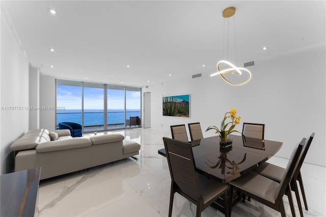 dining space with a notable chandelier, a wall of windows, visible vents, and recessed lighting