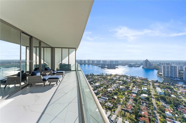 balcony featuring a water view and a view of city