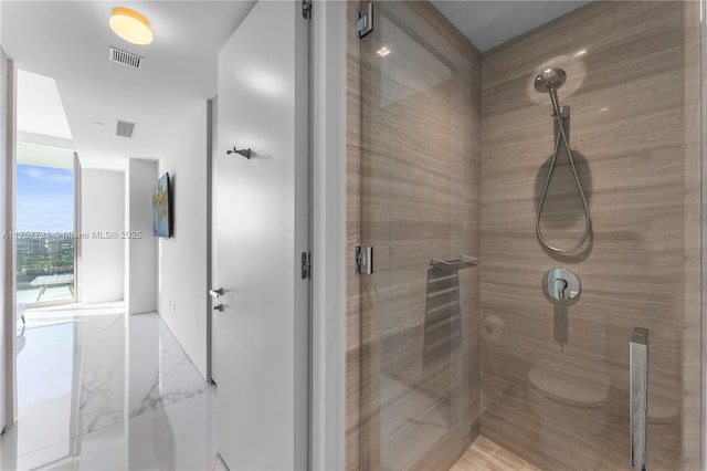 bathroom featuring a stall shower, marble finish floor, and visible vents