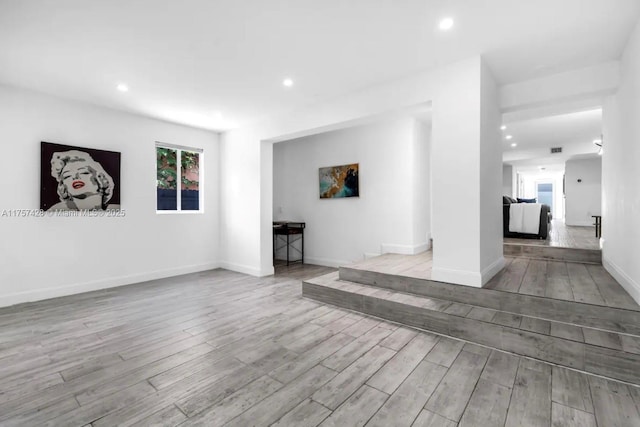 interior space featuring baseboards, wood finished floors, and recessed lighting