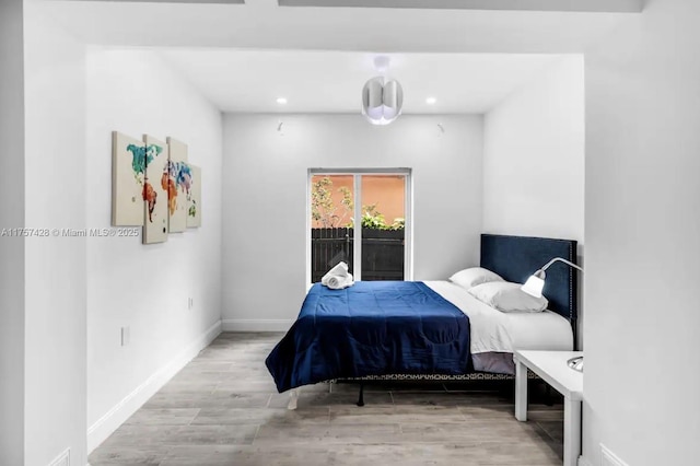 bedroom with baseboards and wood finished floors