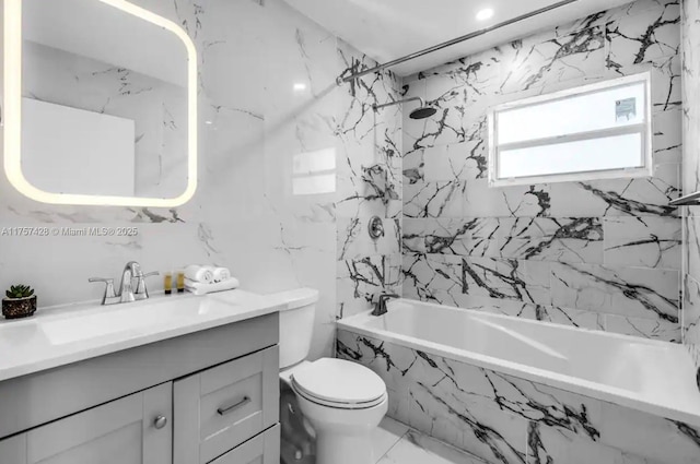 full bathroom featuring toilet, marble finish floor, a combined bath / shower with marble appearance, and vanity