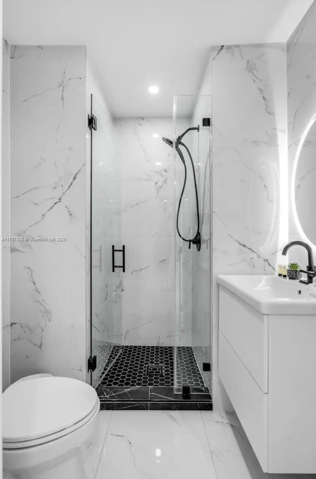 full bath with marble finish floor, stone wall, and toilet