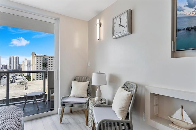 sitting room with a city view and wood finished floors