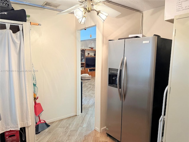 kitchen featuring light wood-type flooring, stainless steel fridge with ice dispenser, visible vents, and ceiling fan