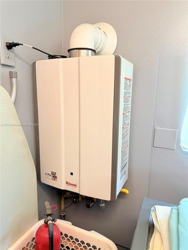 utility room featuring tankless water heater