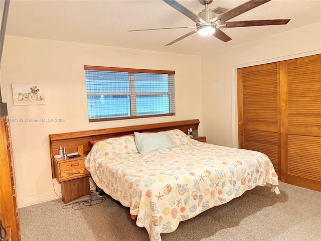 carpeted bedroom featuring a closet and a ceiling fan