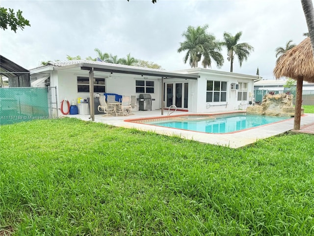 back of house with a fenced in pool, a lawn, fence, and a patio