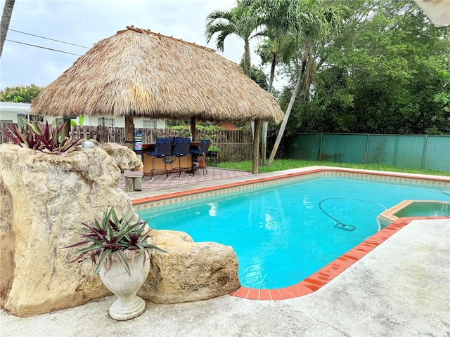 view of pool featuring a fenced in pool, a fenced backyard, a patio, and outdoor dry bar