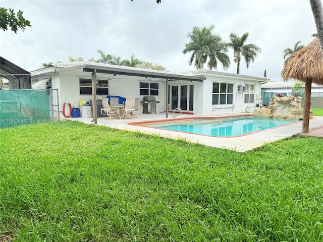 back of property featuring stucco siding, fence, a yard, a fenced in pool, and a patio area