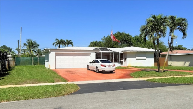 ranch-style house with an attached garage, fence, driveway, stucco siding, and a front yard