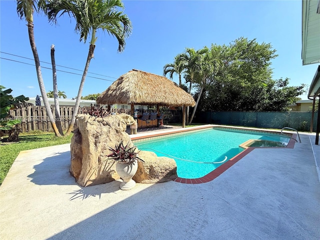 view of pool featuring a gazebo, a pool with connected hot tub, a fenced backyard, and a patio area