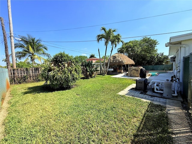 view of yard with a gazebo, a fenced backyard, and a patio area