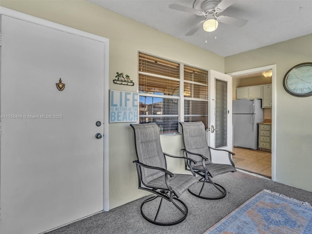 interior space with ceiling fan