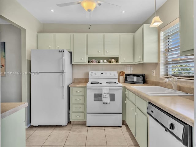 kitchen with white appliances, light countertops, a sink, and light tile patterned flooring