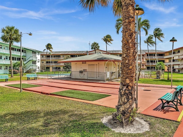 surrounding community featuring fence and a yard