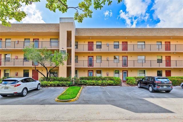 view of property featuring uncovered parking